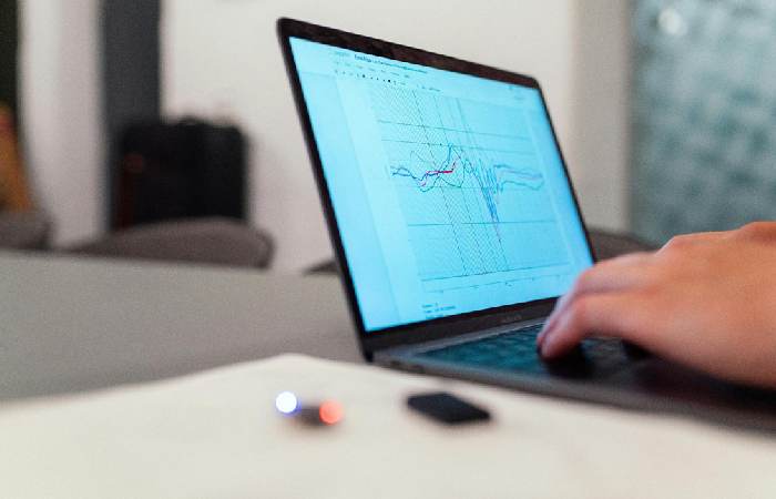 Business team discussing what is RFP software at a conference table with sunlight in the background.